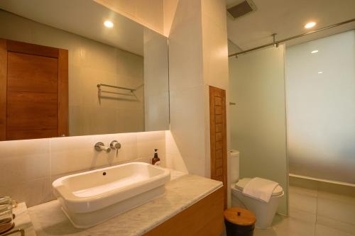 a bathroom with a sink and a toilet at YATS Colony in Yogyakarta