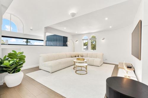 a living room with a couch and a table at Group & Family 3BR with Game Room, Terrace & Parking in Sydney