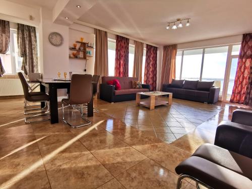 a living room with a couch and a table at Elisa Summerland Apartment in Mamaia