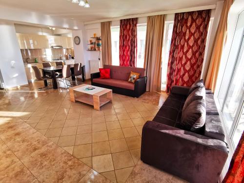 a living room with a couch and a table at Elisa Summerland Apartment in Mamaia