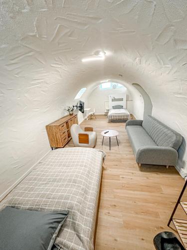 a living room with a couch and a room with an attic at Pension Elisa in Bad Friedrichshall
