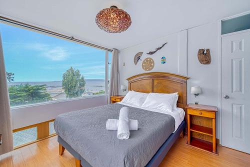 a bedroom with a bed and a large window at Costa Azul- 3D Seafront Apartment in Algarrobo
