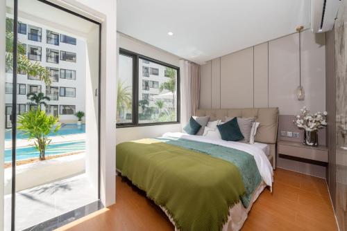 a bedroom with a large bed and a large window at Capri Residence Bangtao in Bang Tao Beach