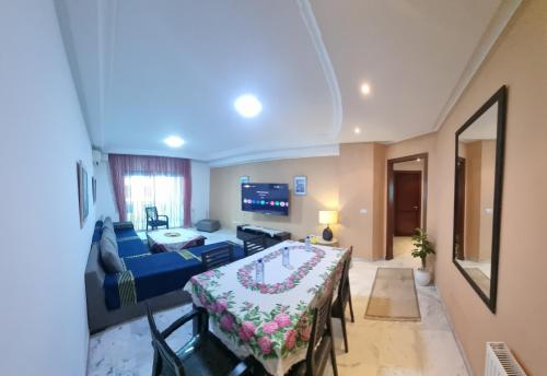 a living room with a blue couch and a table at Luxury home tunisia mall lac 2 in Tunis