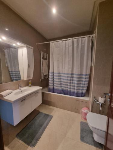 a bathroom with a sink and a toilet and a mirror at Luxury home tunisia mall lac 2 in Tunis