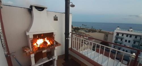 a fireplace on the side of a balcony at terraza al mar in Pineda de Mar