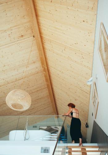 a woman in a room with a glass ceiling at Ostara Ecolodge in Saint-Mards-en-Othe