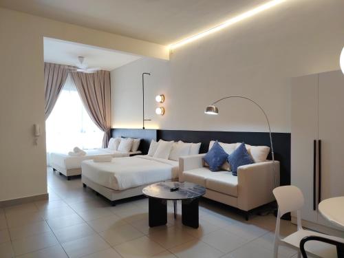 a living room with two beds and a couch at Sunsuria Forum Soho by Diamond in Shah Alam