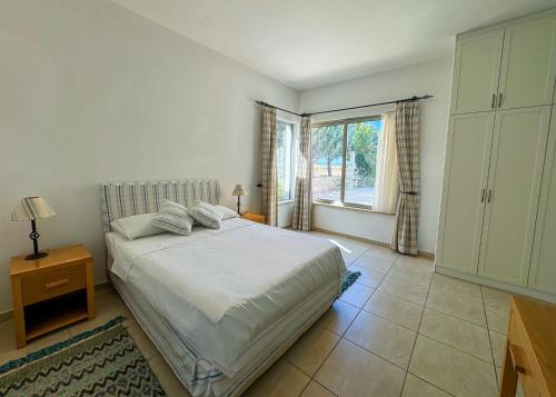 a bedroom with a large bed and a window at Villa Sea View in Kyrenia