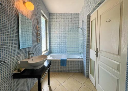 a bathroom with a sink and a bath tub at Villa Sea View in Kyrenia