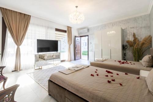 a bedroom with two beds with roses on the floor at Adonis Resort & Spa in Egina