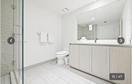 a white bathroom with a toilet and a shower at Hyde house 3507 AL MAR in Hollywood