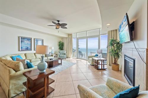 a living room with a couch and a tv at Turquoise Place Beachside Retreat in Orange Beach