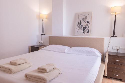 a bedroom with a white bed with towels on it at Casa LoIa Altea By DelucaCo in Altea
