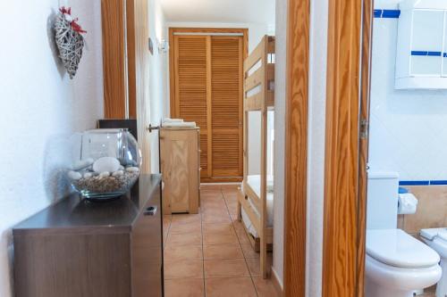 a bathroom with a toilet and a bowl of rocks on a counter at Casa LoIa Altea By DelucaCo in Altea