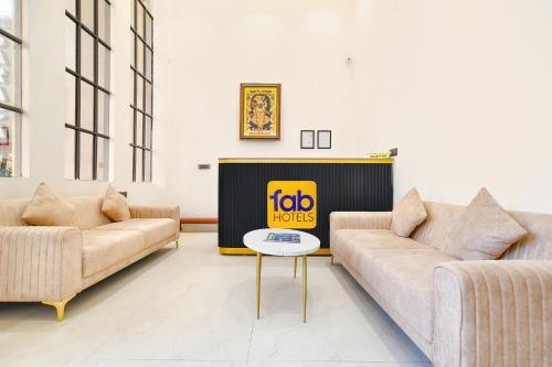a living room with two couches and a tv at FabHotel Saraca Inn in Indore