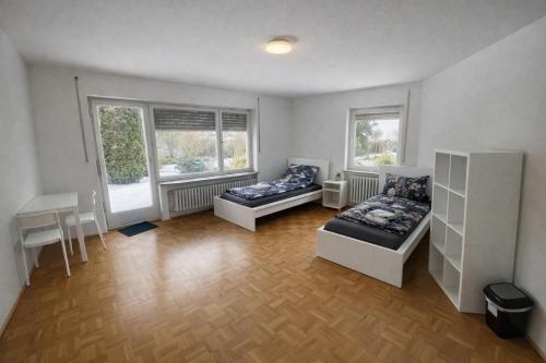 a living room with two beds and a table at Pension am Heckenacker in Rothenburg ob der Tauber
