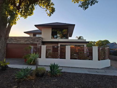 a house with a fence in front of it at Guest Suite, Private Entrance, Bathroom, Garden, No Overlap with Host in Perth
