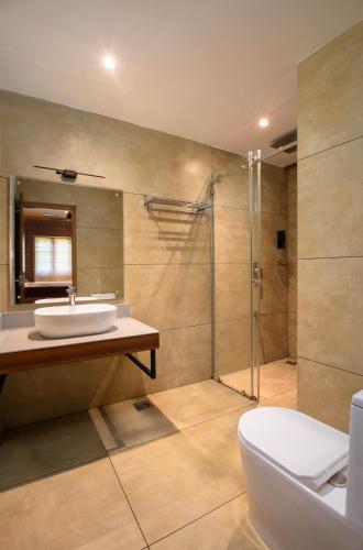 a bathroom with a sink and a shower at Punarjeevani Ayurvedic Heritage in Vythiri