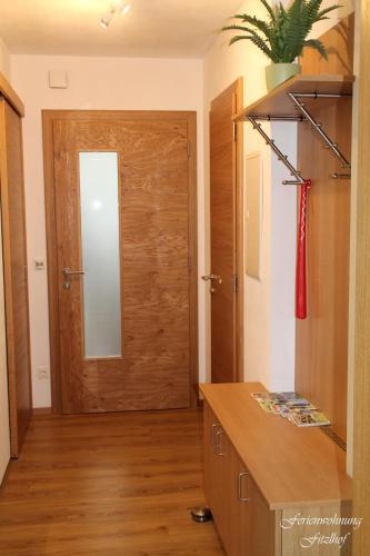 a room with a wooden door and a mirror at Fitzlhof in Sankt Koloman
