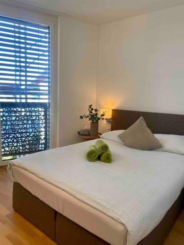 a bedroom with a bed with two towels on it at New and elegant luxury apartment in Kloten