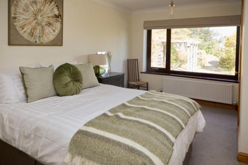 a bedroom with a large bed with a large window at Dukes Well in Congleton