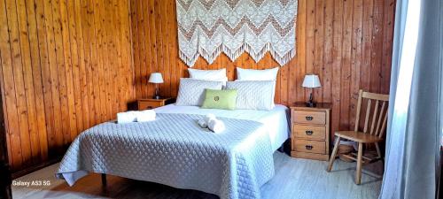 a bedroom with a bed and a wooden wall at Lar da Rita - One bedroom apartment in Água Retorta