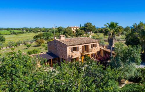an aerial view of a large brick house with trees at Can Moleta in Cala Mendia