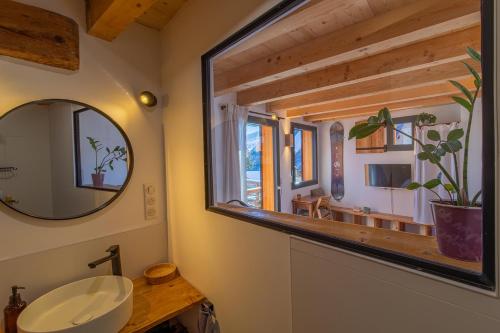 a bathroom with a sink and a mirror at Alesina in Montricher-Albanne