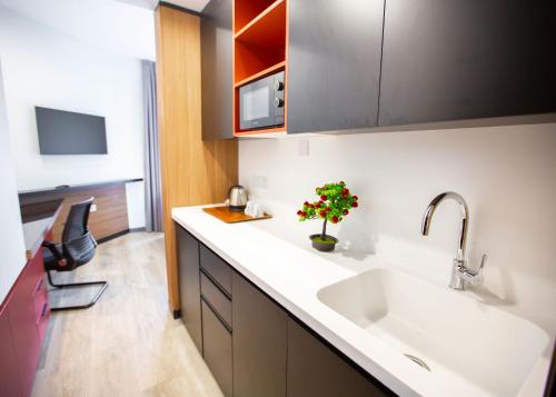 a kitchen with a sink and a counter top at Mediterrian Business Suites by HolidayKeys in Kyrenia