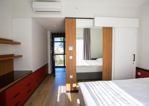 a bedroom with two beds and a window at Mediterrian Business Suites by HolidayKeys in Kyrenia