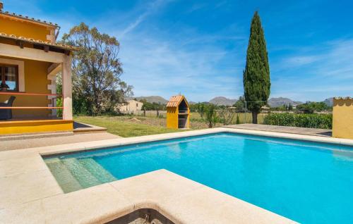 a swimming pool in front of a villa at Can Jaume Pollenca in Pollença