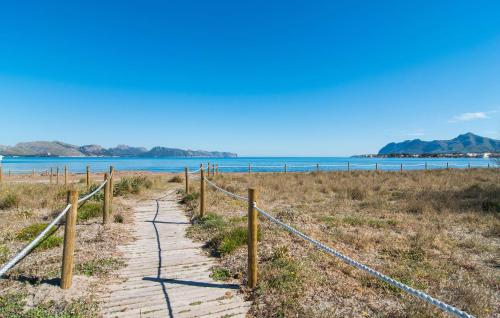 a path leading to the beach with the ocean in the background at Sa Fornera in Alcudia
