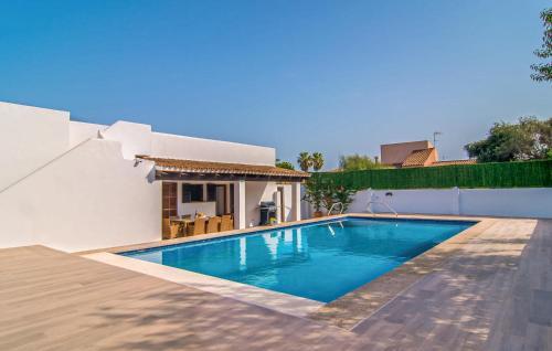 a swimming pool in the backyard of a house at Murta 26 in Sa Coma