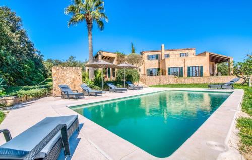 a swimming pool in front of a house at Esteva in Sant Llorenç des Cardassar