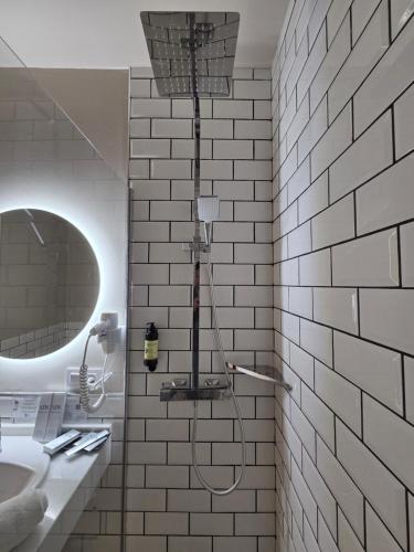 a shower in a bathroom with a white tiled wall at Hotel Boutique Convento Cádiz in Cádiz