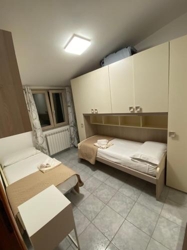 a room with two beds and cabinets in it at Da Gin in Bosa Marina