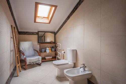 a bathroom with a toilet and a sink at Beachfront Penthouse with Panoramic Ocean-View Terrace VIP Baia in Machico