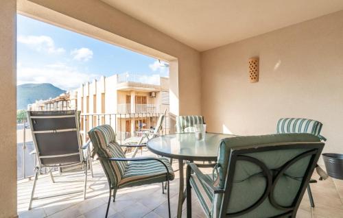 a dining room with a table and chairs on a balcony at Atico Roger De Flor in Port de Pollensa