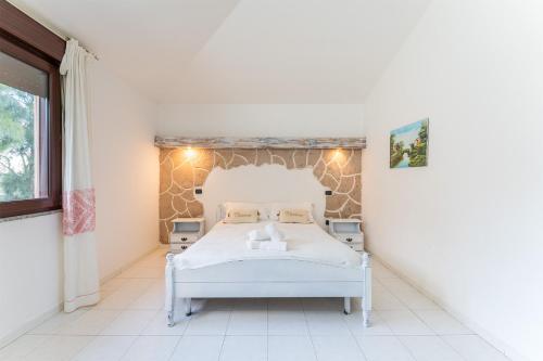a bedroom with a white bed and a window at Charme in Solèminis