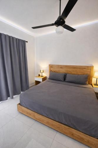 a bedroom with a bed with a ceiling fan at Ivy Villa Cabarete, fully equipped villa in Cabarete