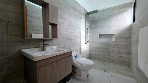 a bathroom with a sink and a toilet and a shower at Ivy Villa Cabarete, fully equipped villa in Cabarete