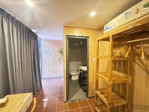 a bathroom with a toilet and a glass doorway at Guest House Thiên Thanh in Phú Quốc