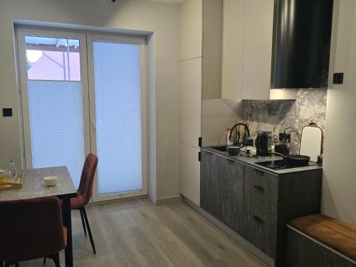a kitchen with a table and a counter top at Hotel-24 in Płock