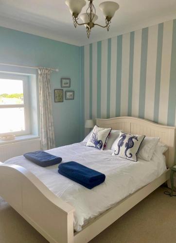 a bed with two blue pillows on it in a bedroom at Skyline Oasis in Portsmouth