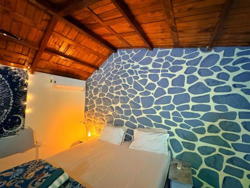 a bedroom with a white bed with a blue and white wall at Captans Stay in Lonavala