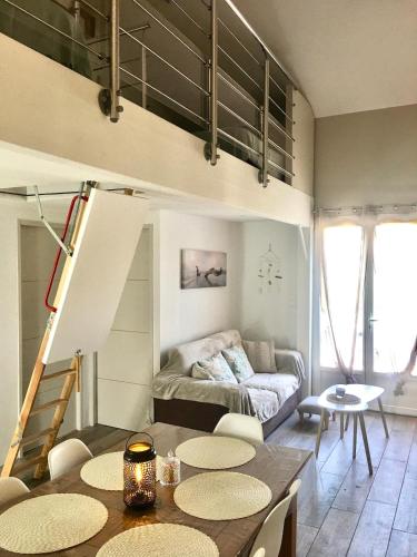 a living room with a table and a couch at Maison côté lac in Parentis-en-Born