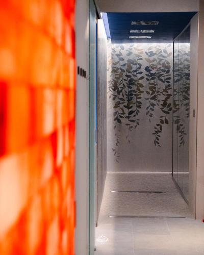 a hallway with a glass door in a library at Albergo Parco Gran Sasso in Castel del Monte