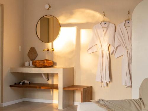 a dressing room with a robe hanging on a wall at Casa Bora Hotel Boutique in San Antonio de Areco