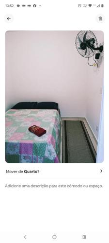 a picture of a bedroom with a bed with a comforter at Suites Aeroporto in Campinas